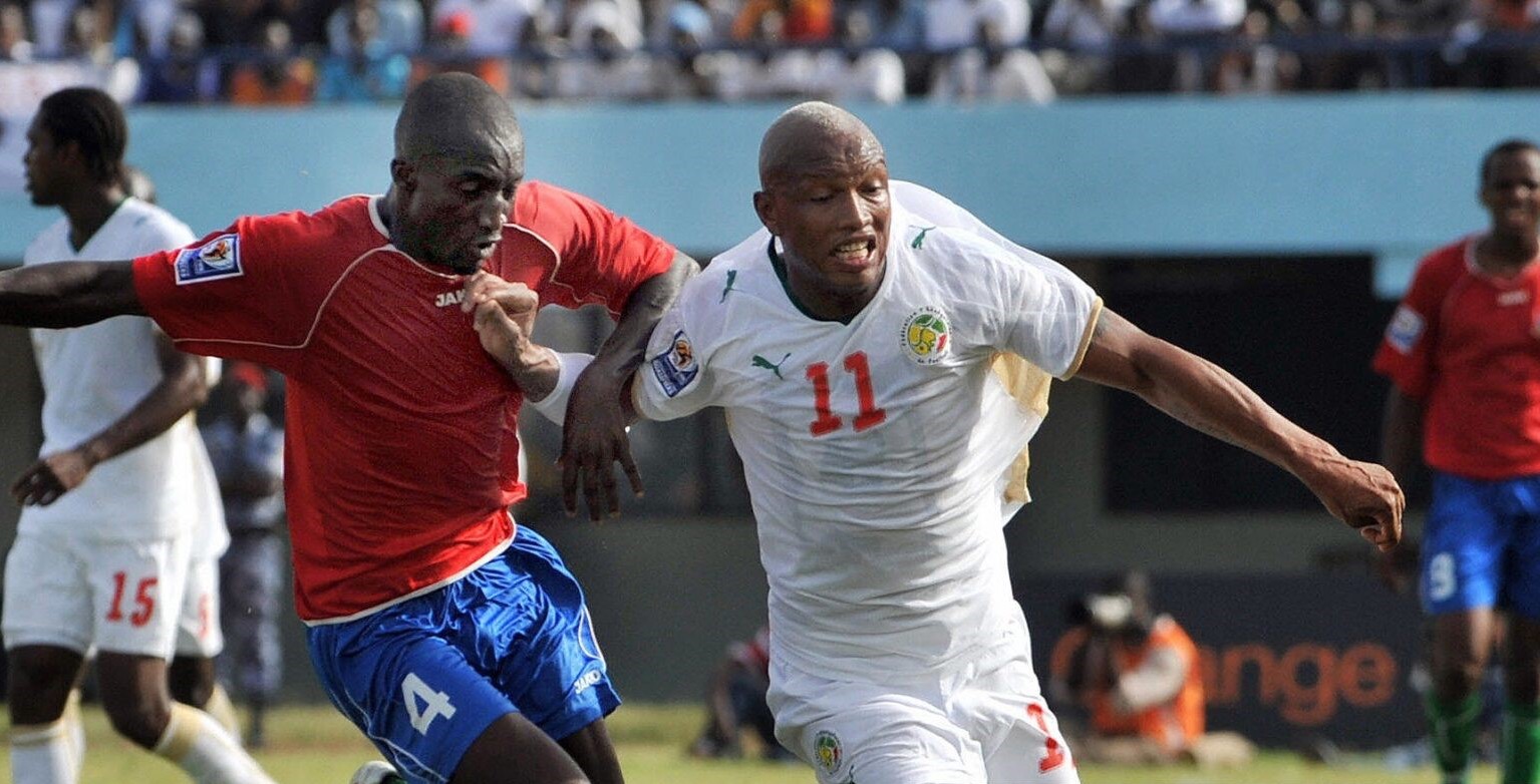 El-hadji-Diouf-battles-with-Mathew-Mendy-in-Gambia’s-1-1-draw-with-Senegal-in-Dakar